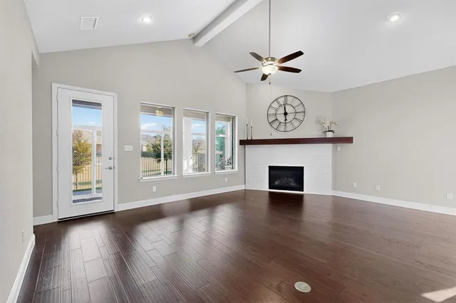 a kitchen with granite countertop a stove top oven a sink dishwasher a dining table and chairs with wooden floor