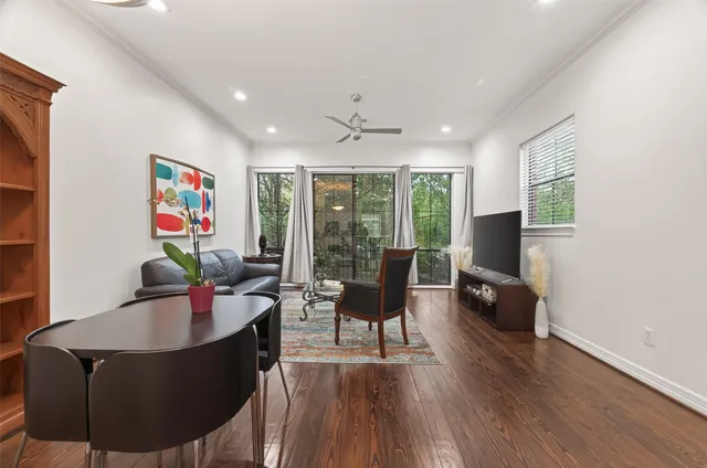 a living room with furniture and a floor to ceiling window