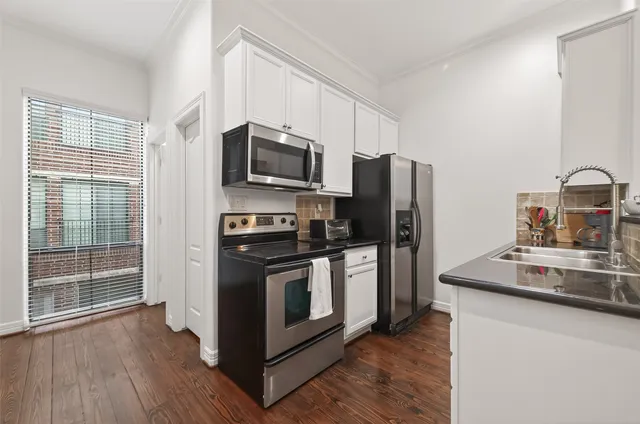 a kitchen with wooden cabinets and stainless steel appliances