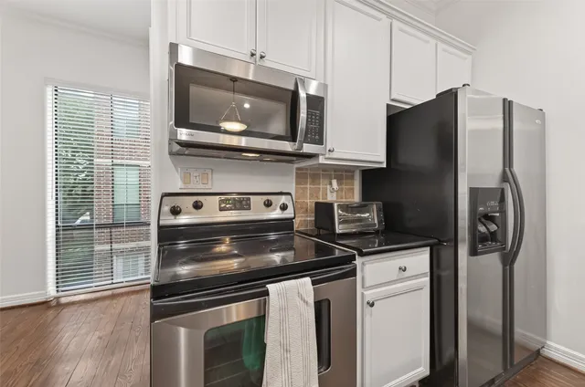 a kitchen with stainless steel appliances and wooden cabinets