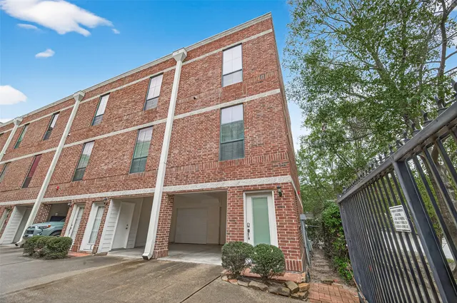 a front view of a house with a tree