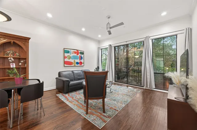 a work room with furniture wooden floor and a floor to ceiling window