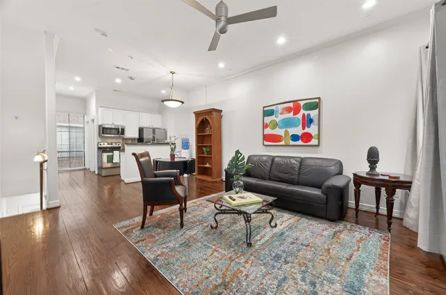 a living room with furniture and kitchen view