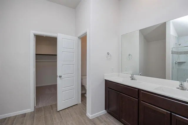 a bathroom with a double vanity sink and mirror