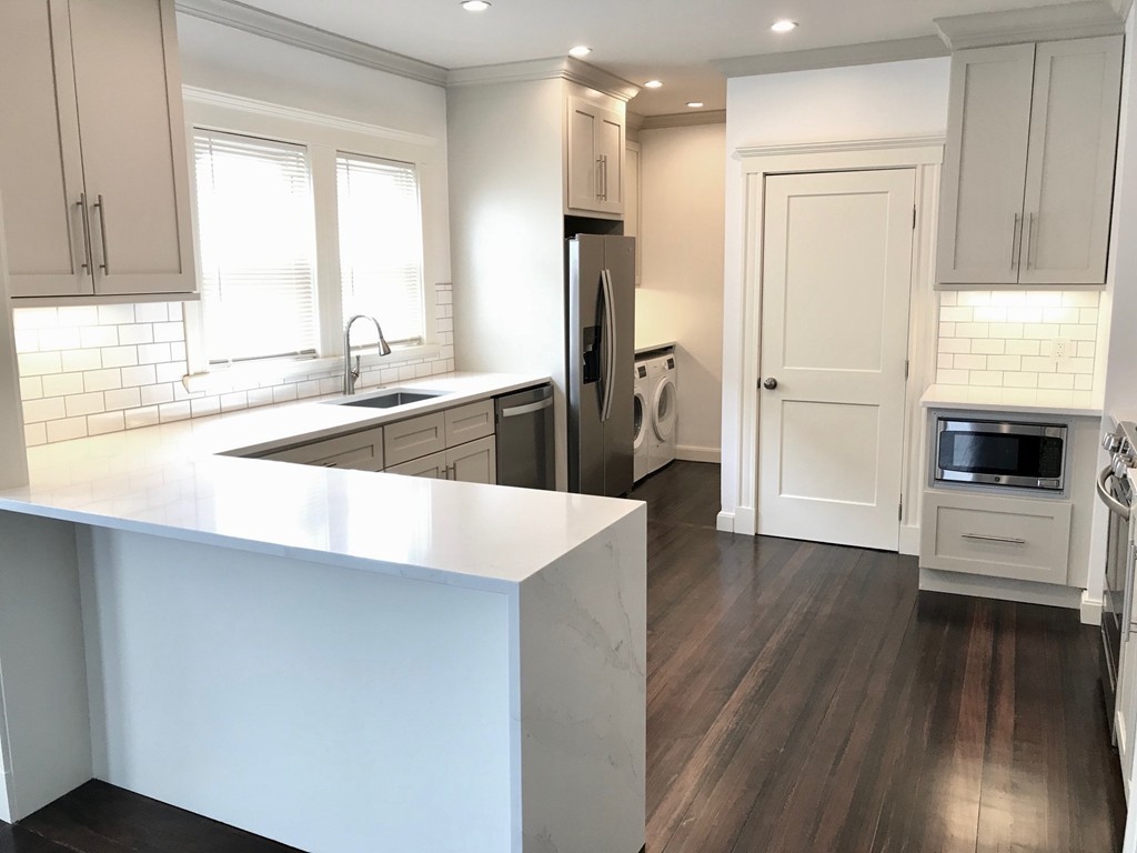 a bathroom with a sink a bathtub and a window