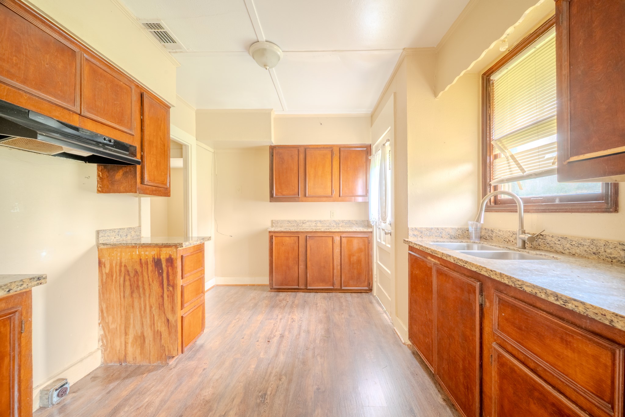 603 North Resident Street Wharton, TX 77488 - Photo 25 of 45 a large kitchen with a wooden floor and a large window