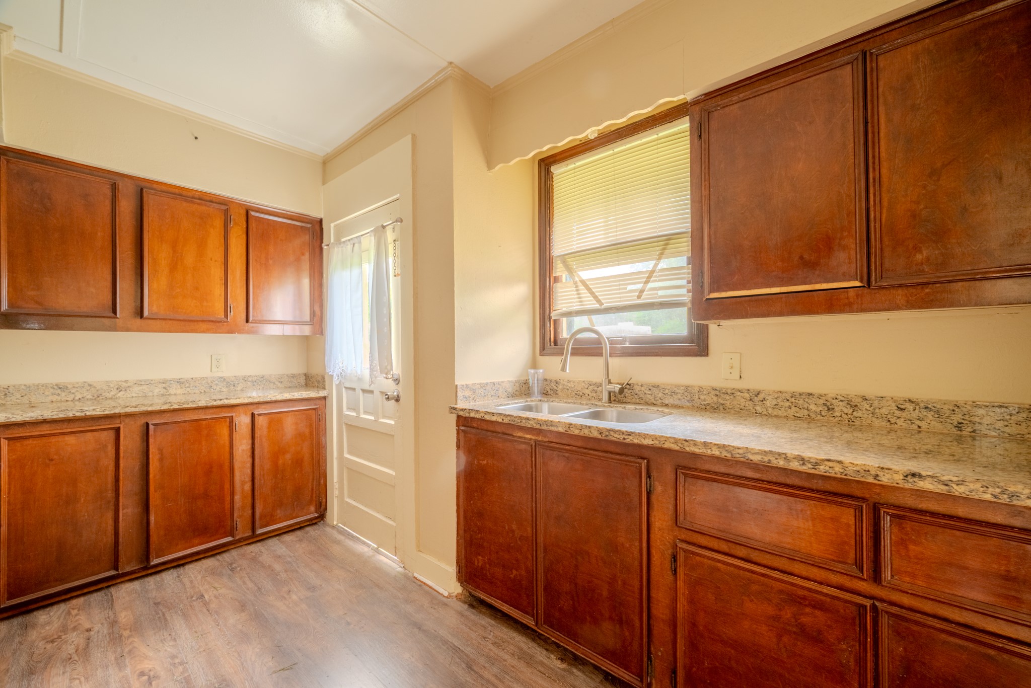 603 North Resident Street Wharton, TX 77488 - Photo 27 of 45 a kitchen with stainless steel appliances granite countertop wooden cabinets a sink and a window