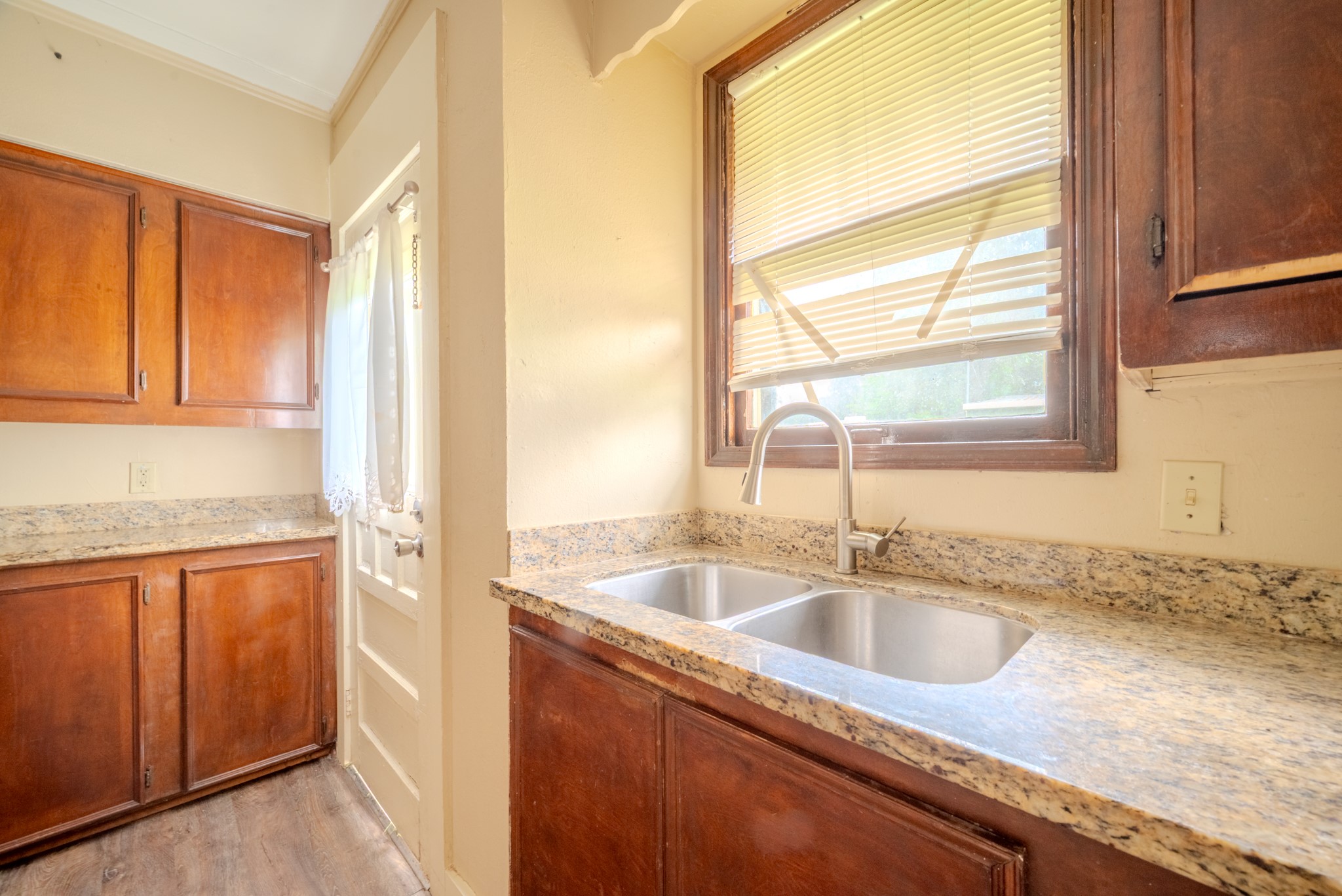 603 North Resident Street Wharton, TX 77488 - Photo 28 of 45 a kitchen with granite countertop a sink and a window