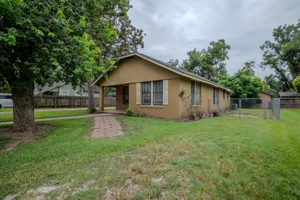 a front view of house with yard and green space