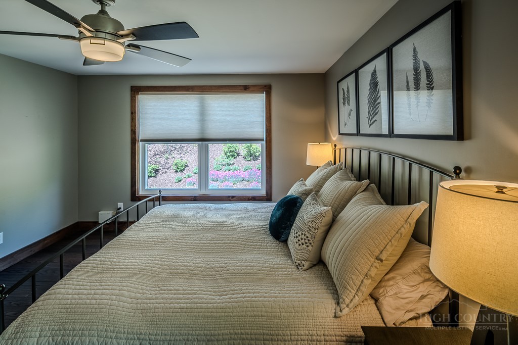 210 Grand Creek Road Vilas, NC 28692 - Photo 21 of 40 a bedroom with a bed and a window