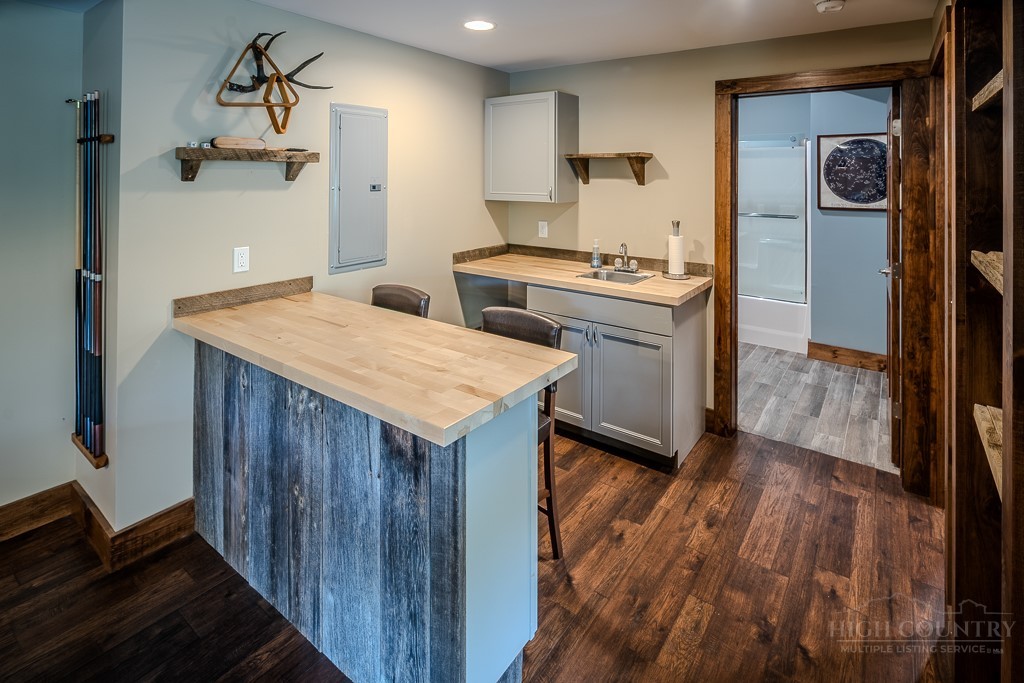210 Grand Creek Road Vilas, NC 28692 - Photo 34 of 40 a kitchen with a wooden floor and cabinets