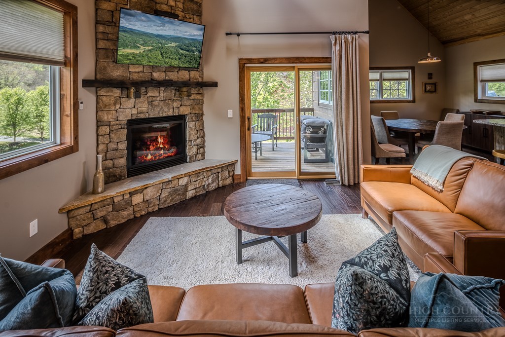 210 Grand Creek Road Vilas, NC 28692 - Photo 7 of 40 a living room with furniture and a fireplace