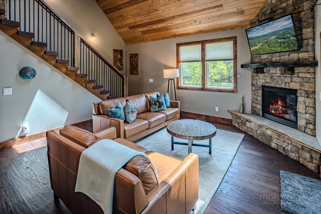 210 Grand Creek Road Vilas, NC 28692 - Photo 10 of 40 a living room with furniture fireplace and a large window