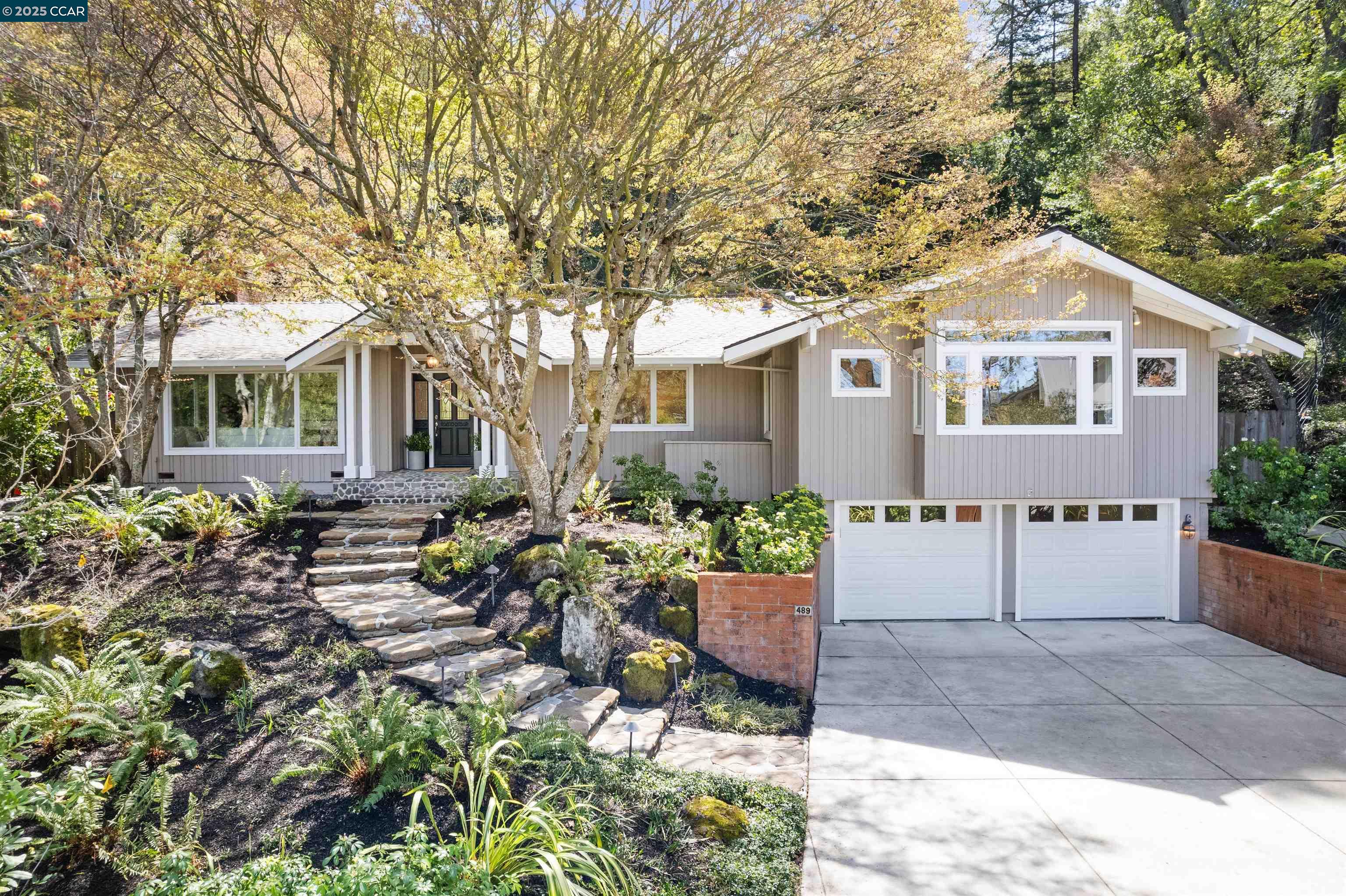 a front view of a house with garden