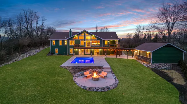 a view of a backyard with table and chairs a fire pit and a yard