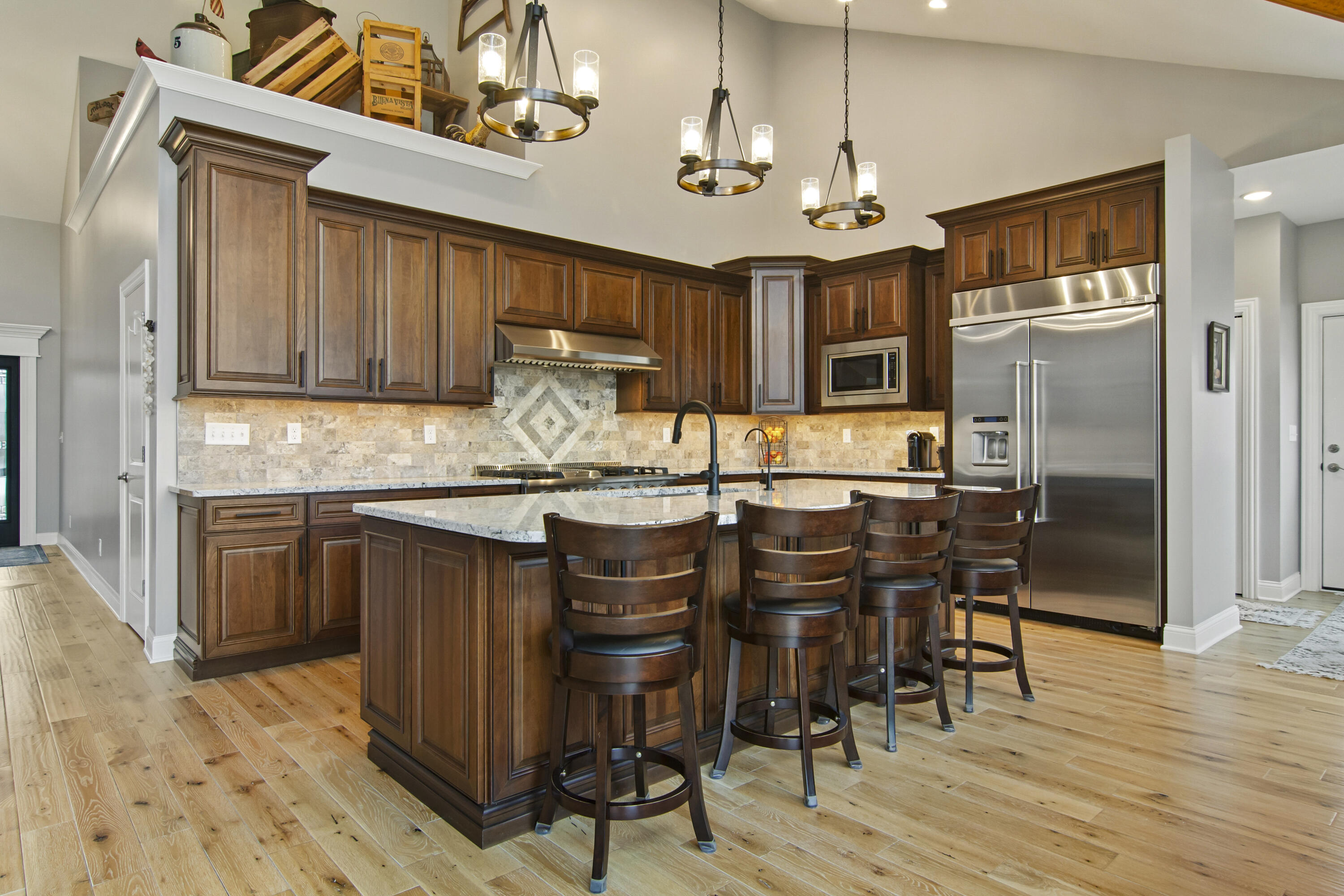 16489 Harrison Street Lowell, IN 46356 - Photo 17 of 67 a kitchen with stainless steel appliances granite countertop a dining table chairs refrigerator and cabinets