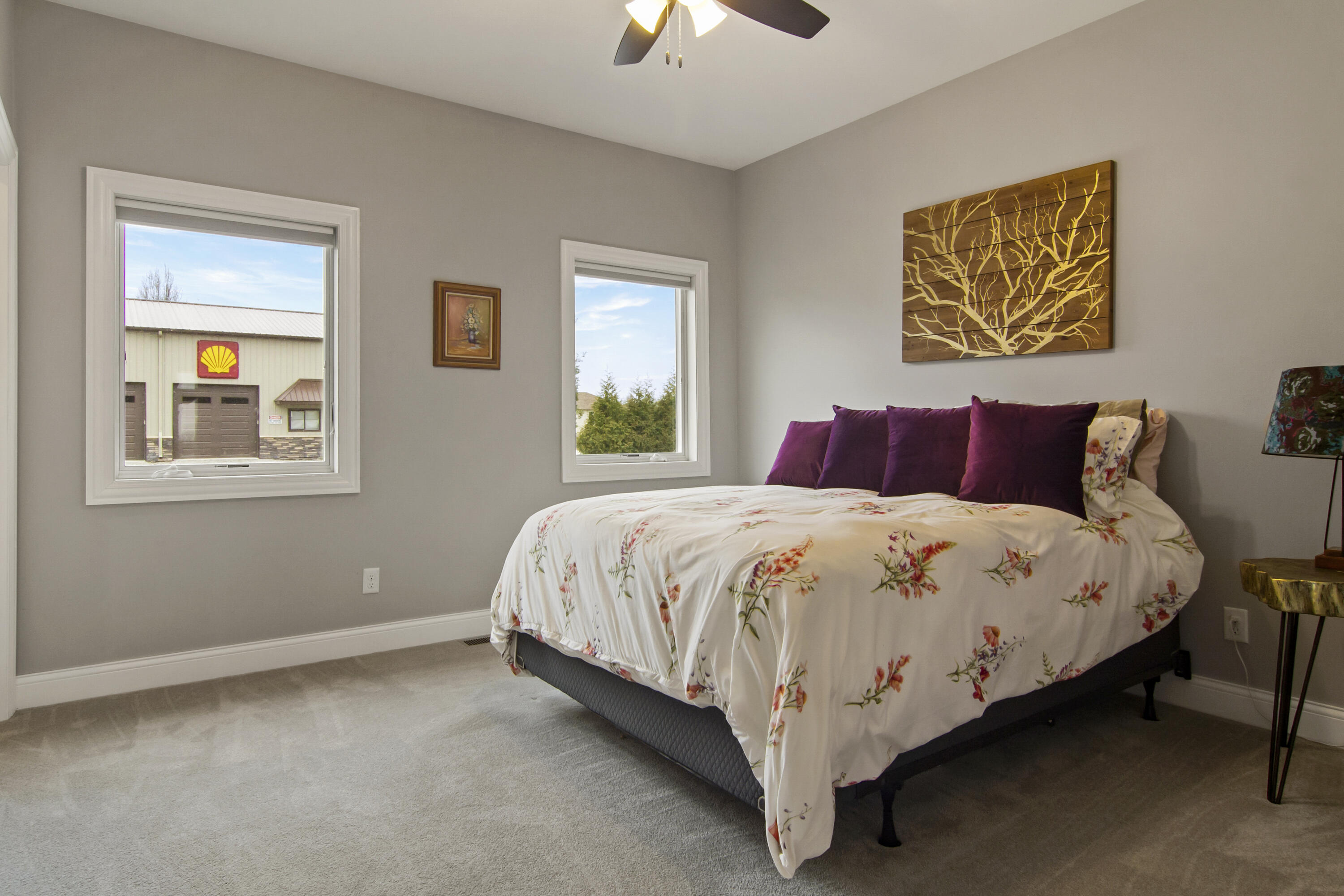 16489 Harrison Street Lowell, IN 46356 - Photo 35 of 67 a large bed sitting in a bedroom next to a lamp and a chandelier