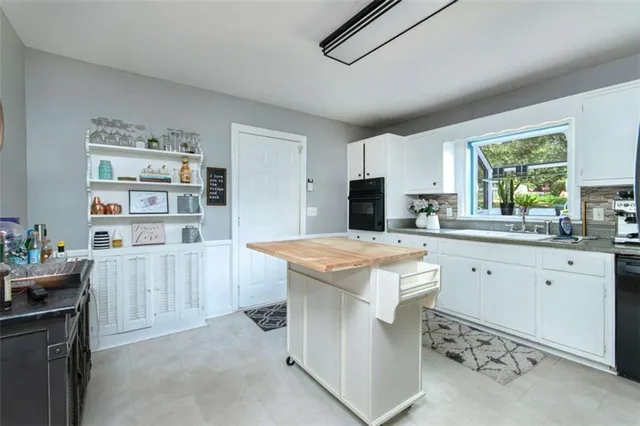 a kitchen with cabinets and window