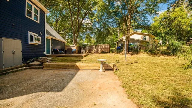a view of a house with snow on the side of the road
