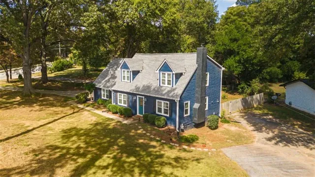 a view of a house with a yard covered with snow