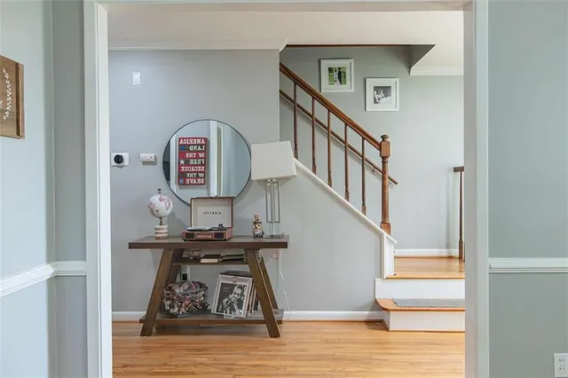 a view of entryway and hall with wooden floor