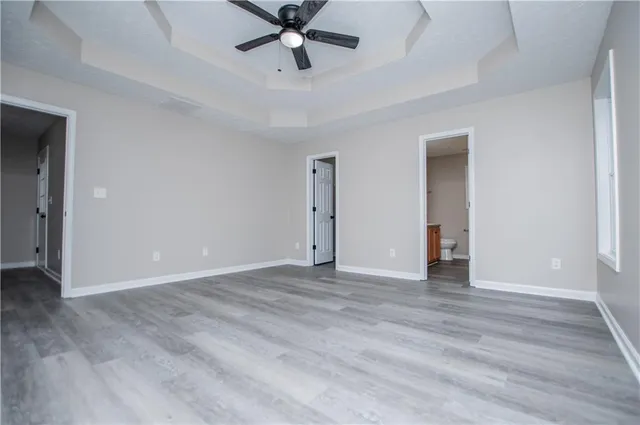 a view of an empty room and wooden floor