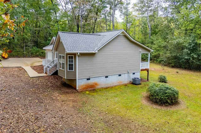 a view of a house with a yard and wooden fence