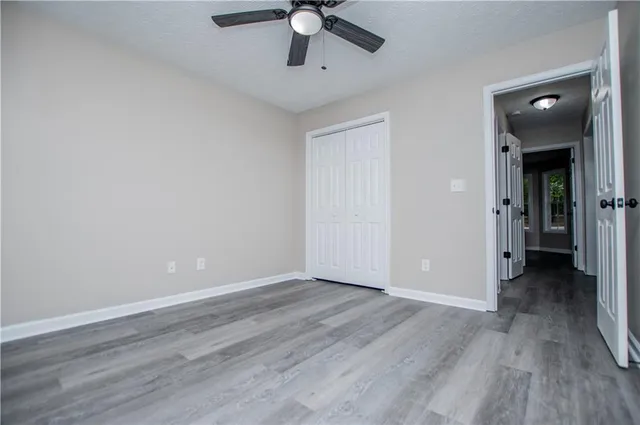 a view of a house with pool and a yard
