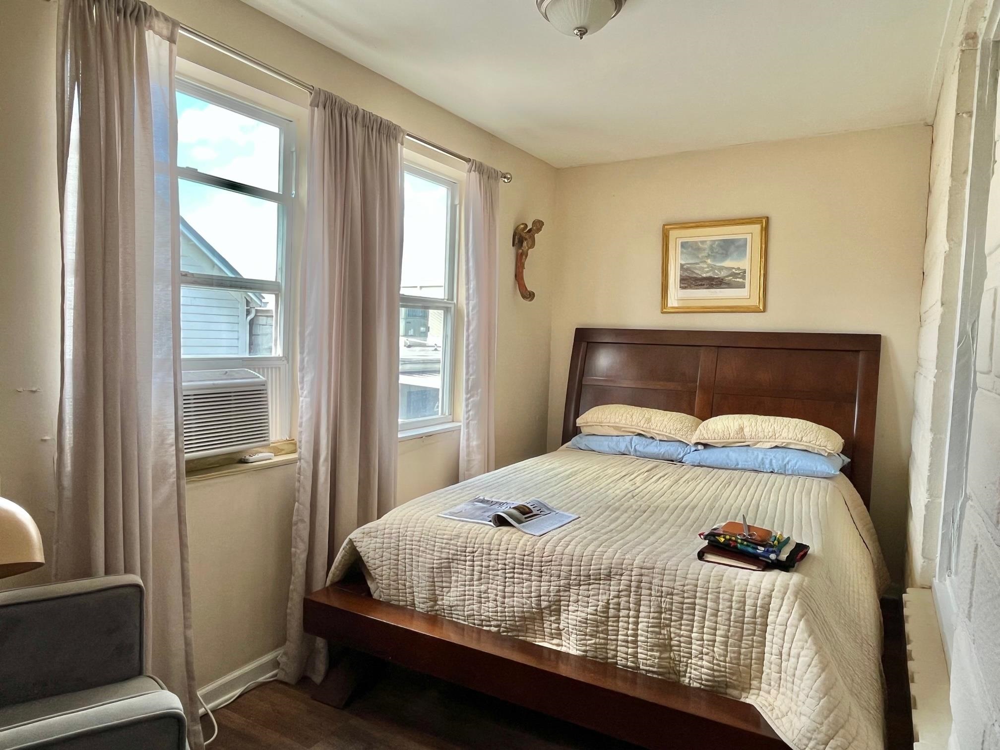 138 King Street, Unit D St. Augustine, FL 32084 - Photo 6 of 12 a bedroom with a bed and wooden floor
