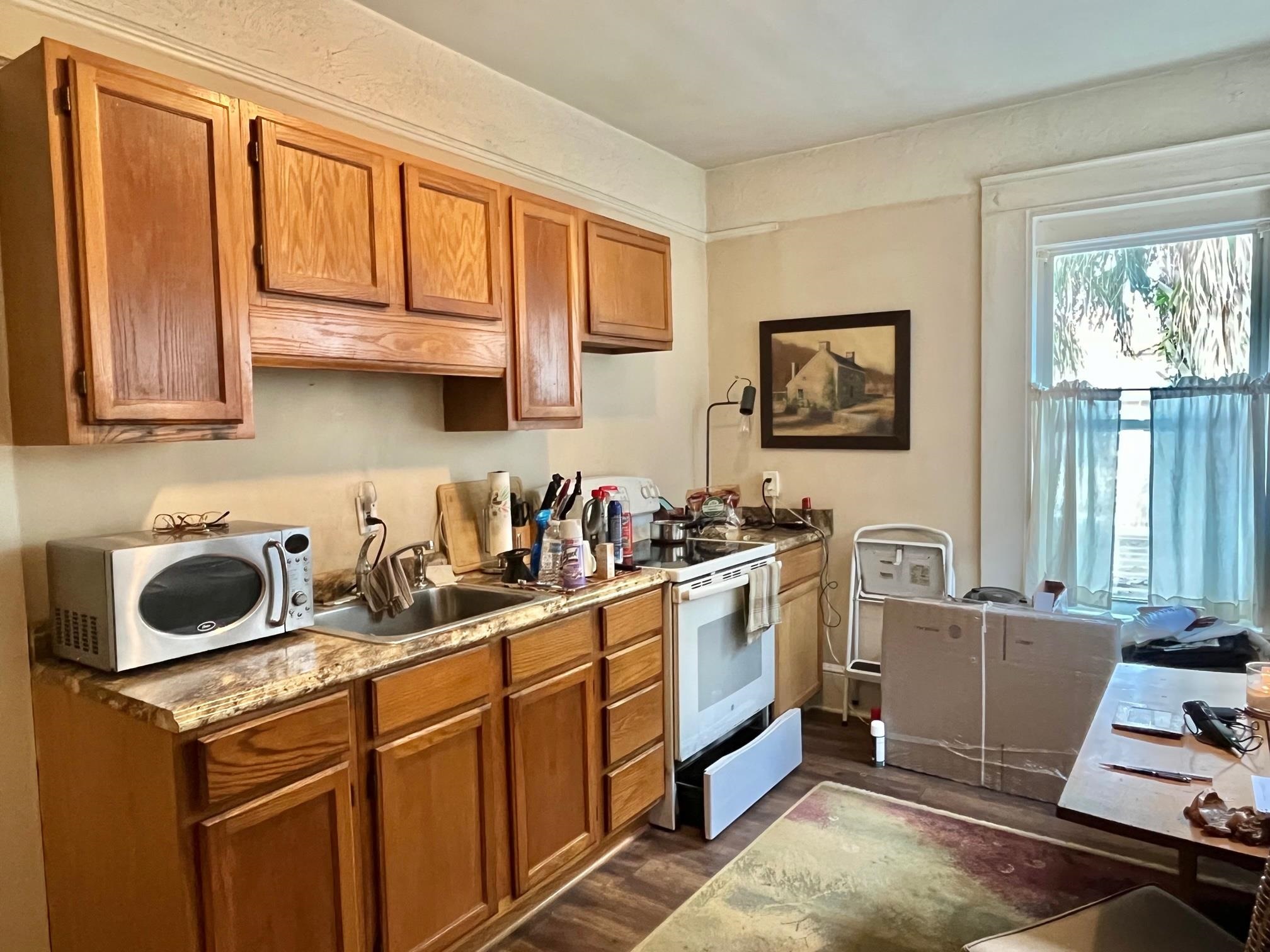 138 King Street, Unit D St. Augustine, FL 32084 - Photo 10 of 12 a kitchen with stainless steel appliances granite countertop a sink stove and cabinets