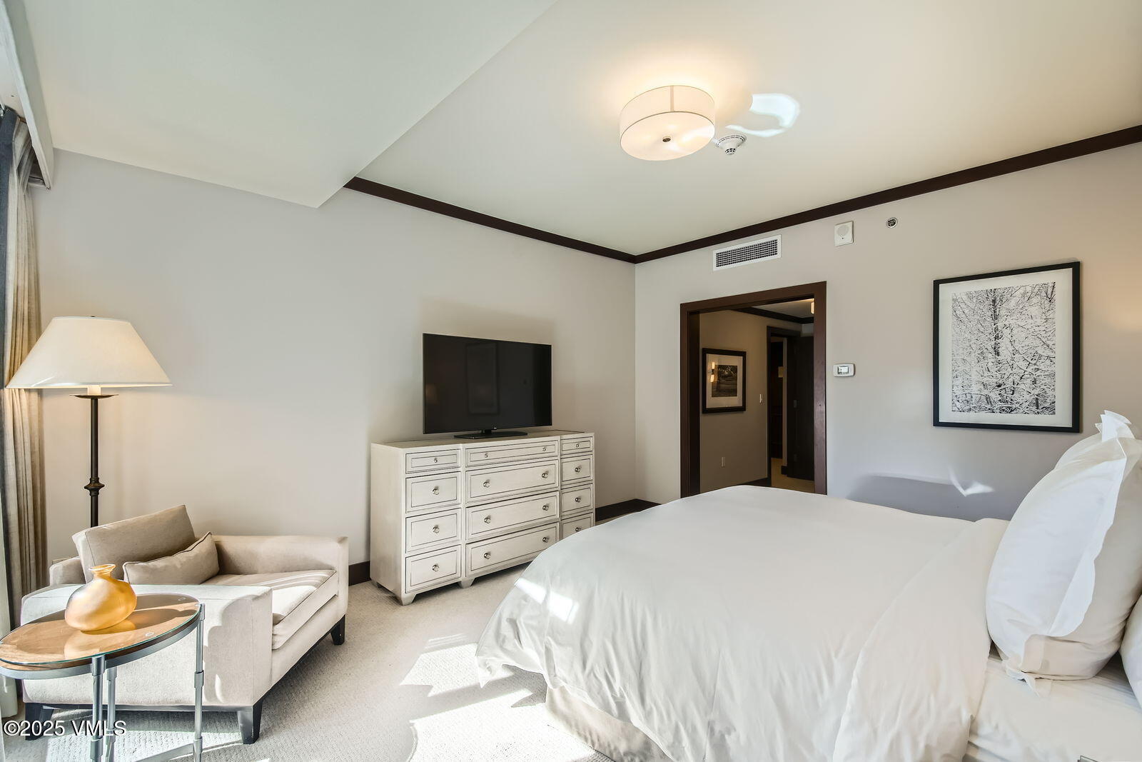 1 Vail Road, Unit 8101F Vail, CO 81657 - Photo 17 of 28 a bedroom with a bed and a chandelier