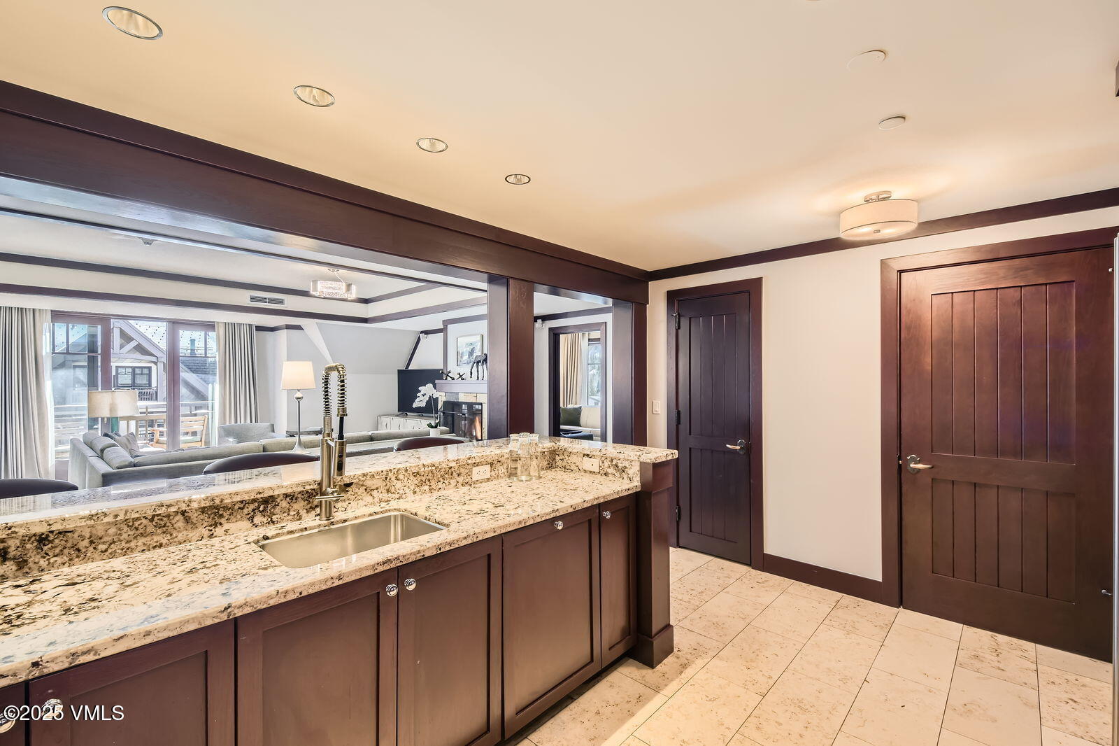 1 Vail Road, Unit 8101F Vail, CO 81657 - Photo 10 of 28 a bathroom with a granite countertop sink and a large mirror