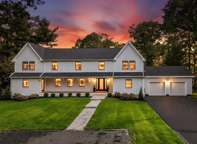 a front view of a house with a garden and yard