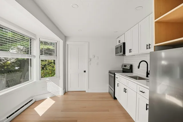 a kitchen with granite countertop a sink and cabinets