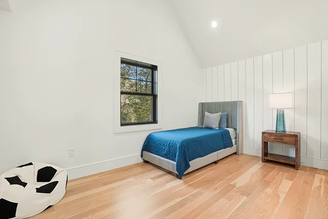 a bedroom with a bed and a large window