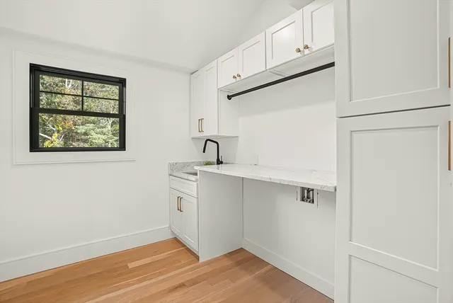 a view of a kitchen with wooden floor and window