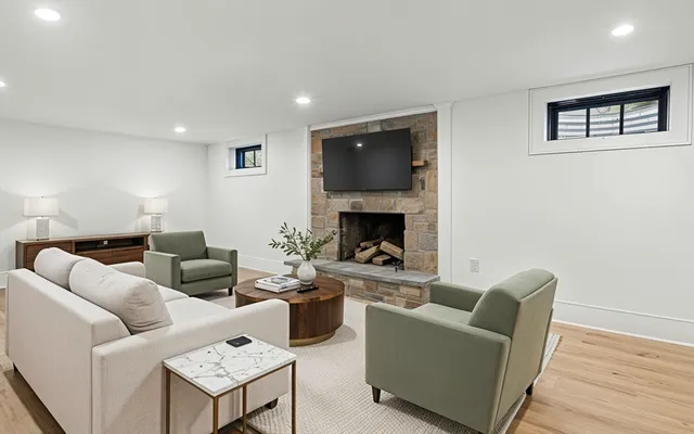 a living room with furniture and a fireplace