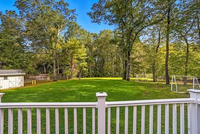 a view of a deck with a big yard