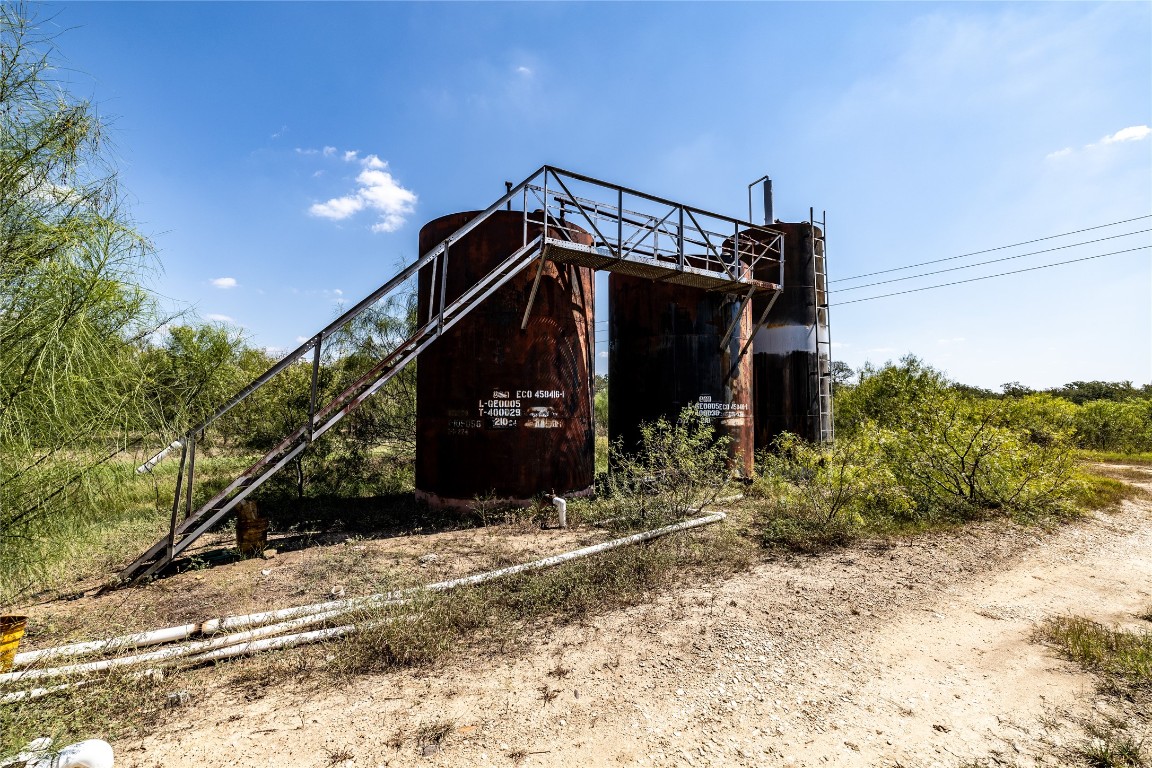 Tbd Lot 1 Tbd Road Red Rock, TX 78662 - Photo 10 of 12 a view of a wooden house with a large tree