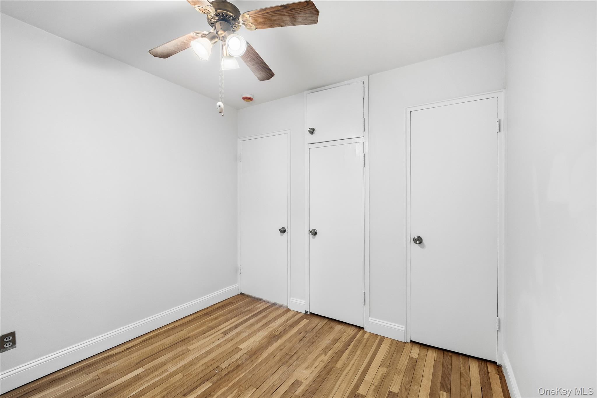 228-08 Stronghurst Avenue, Unit LOWR Queens, NY 11427 - Photo 13 of 20 a view of empty room with wooden floor