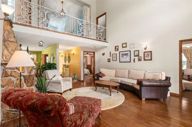 a very nice looking living room with a large window and dining table