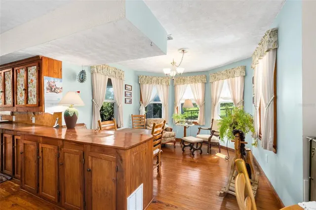 a kitchen with a sink appliances cabinets and a large window