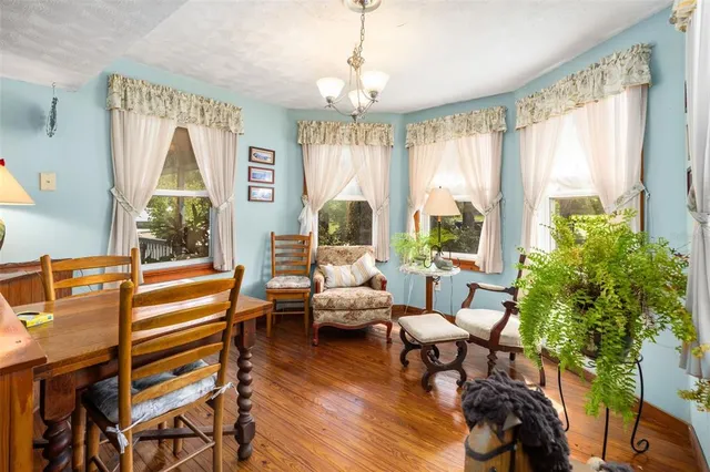 a bathroom with a sink a toilet a mirror and a window