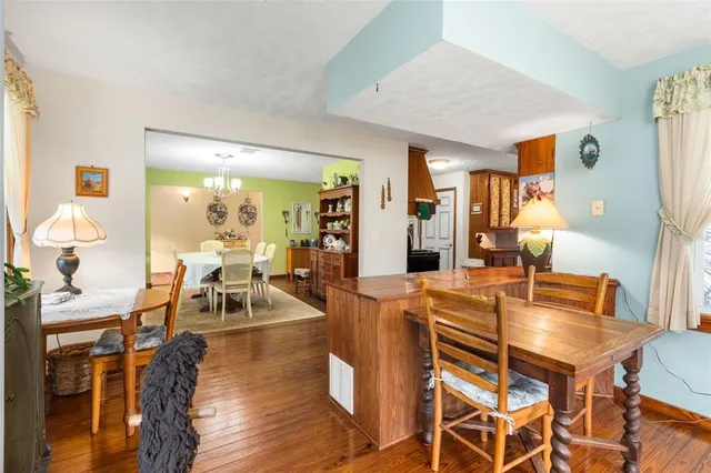 a kitchen with stainless steel appliances a stove a sink dishwasher and a refrigerator with wooden floor