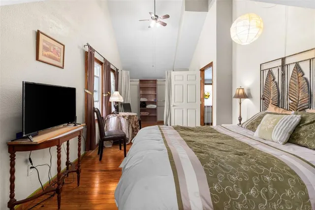 a view of a house with a big yard and large trees