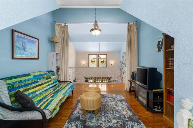 a view of a porch with chairs and potted plants