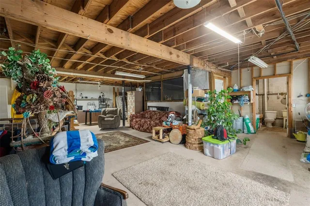 a view of a balcony with chairs and wooden fence