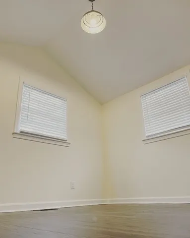 a view of a room that has a window and cabinets