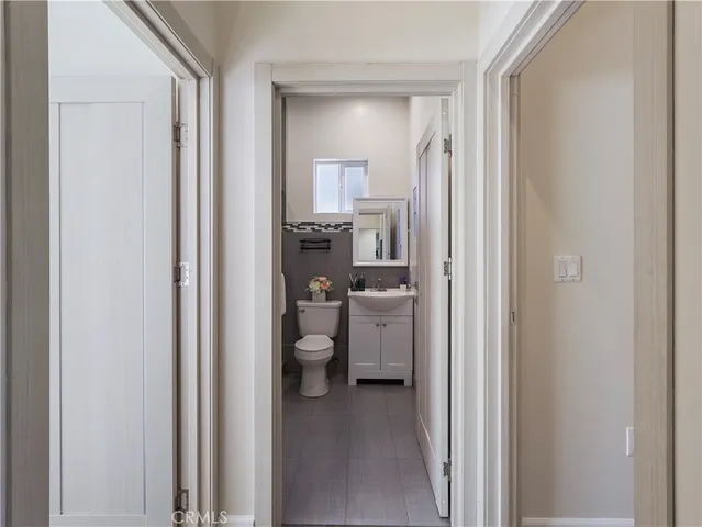 a bathroom with a granite countertop sink mirror vanity and toilet