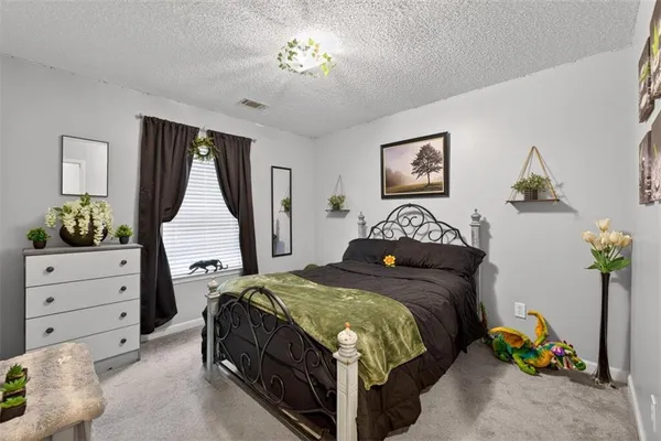 a bedroom with bed and window